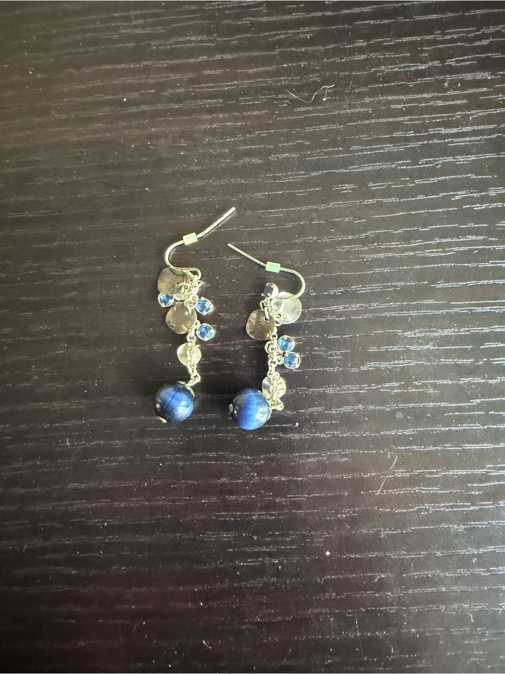 Silver-tone dangle earrings accented with a striking blue cat's-eye bead